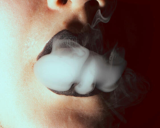 Smoke escaping from black lips